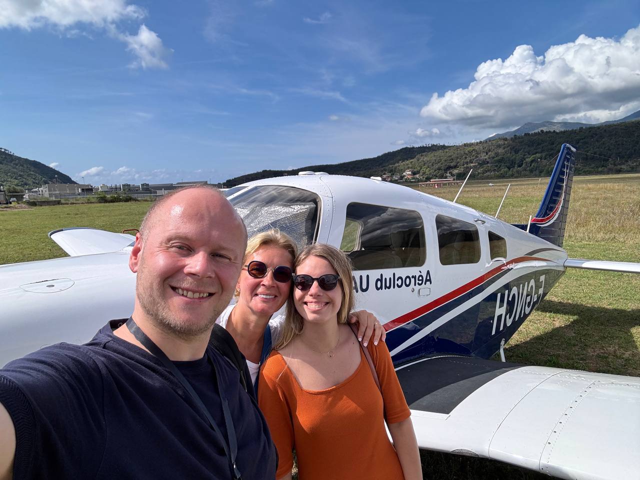 Alex Gervash with family in front of a small aircraft